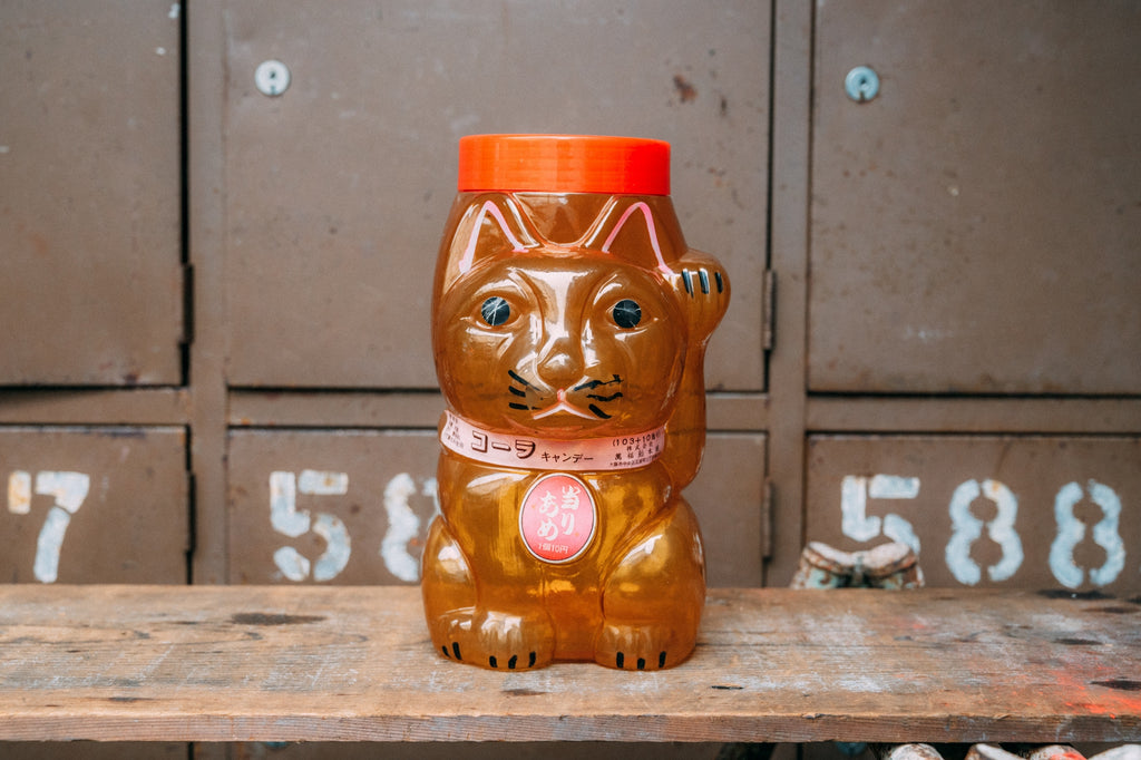 招き猫の形をした飴色の半透明プラスチック容器